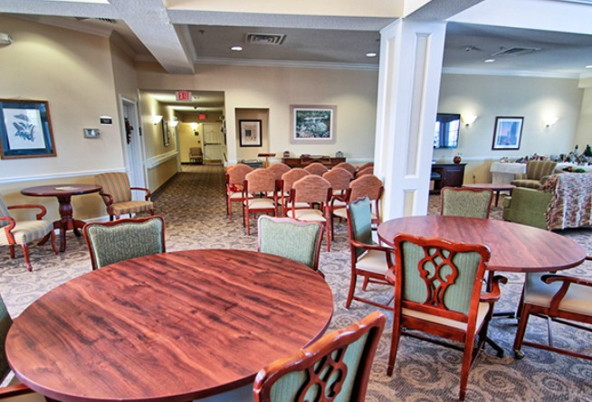 A cozy lounge area with multiple seating arrangements and wooden tables.