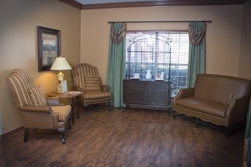 A cozy living room featuring comfortable chairs and natural light from the window.