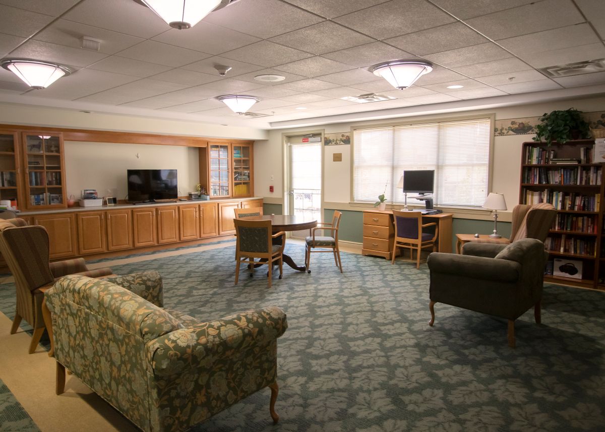 A cozy lounge area with comfortable seating and a television.
