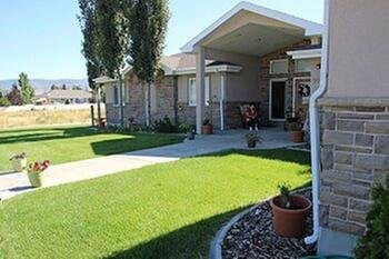 A suburban house with a well-maintained lawn and driveway.