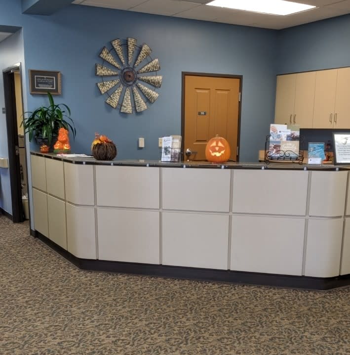 A reception area decorated for Halloween with pumpkins and a welcoming atmosphere.