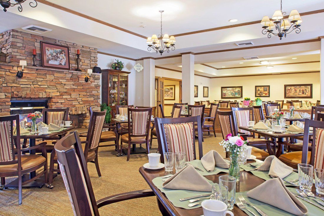 A well-decorated dining room with neatly arranged tables and chairs, ready for guests.