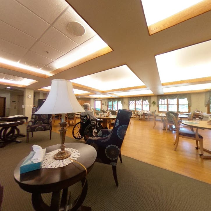 A spacious and well-lit interior seating area with tables and chairs.