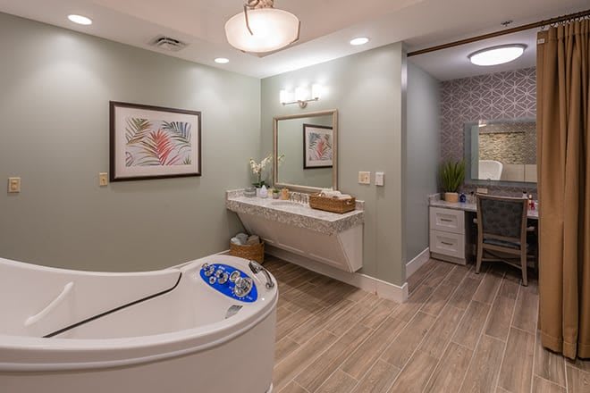 A serene spa room with a modern tub, soothing decor, and elegant lighting.