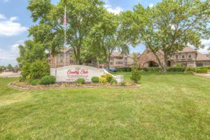 Entrance to an apartment complex with well-maintained landscaping.