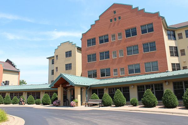 A hotel building with a prominent entrance and landscaped surroundings.