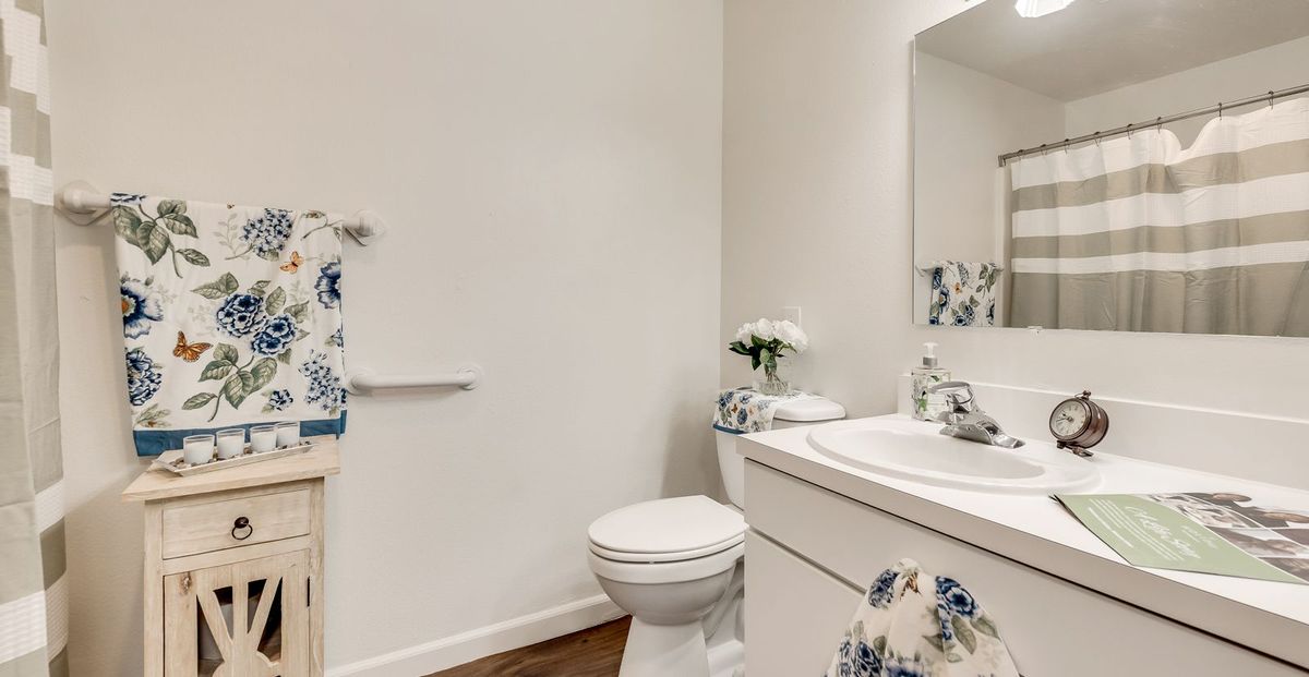 A clean, modern bathroom with floral decorations and elegant design.