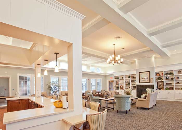 A spacious and cozy living room with modern furniture and a chandelier.