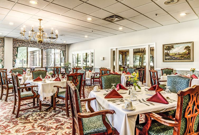 An elegant restaurant dining room with beautifully set tables and classic decor.