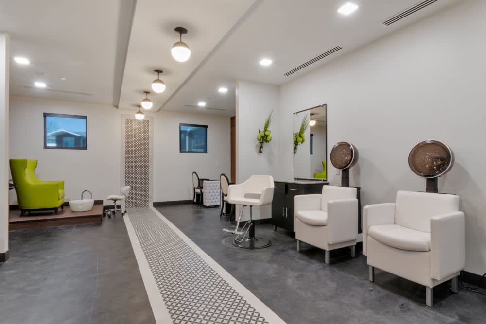 A modern and stylish salon interior with comfortable seating and elegant lighting.