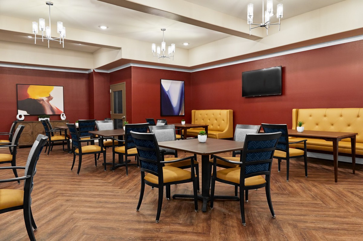 A modern dining area with stylish furniture and warm lighting.