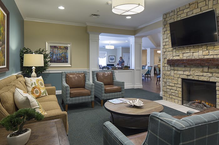 A cozy living room featuring comfortable seating, a coffee table, and a television.