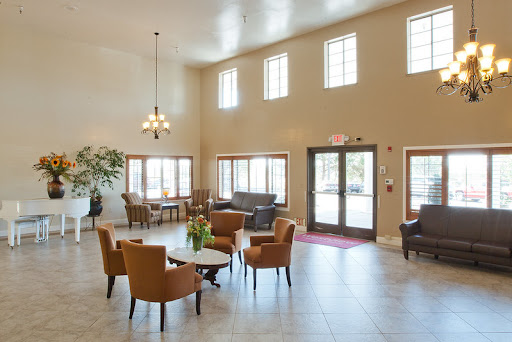 A spacious and inviting lobby featuring comfortable seating, large windows for natural light, and a modern design.