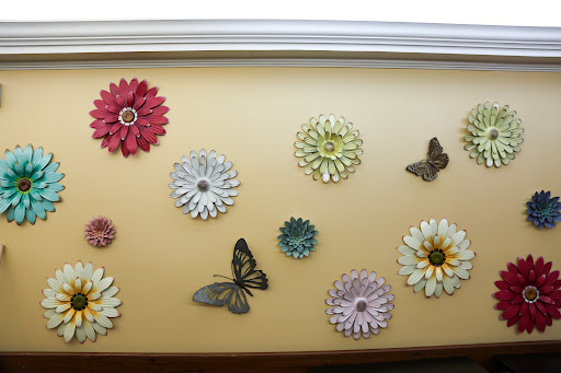 A vibrant display of decorative flowers and butterflies adorning a wall.