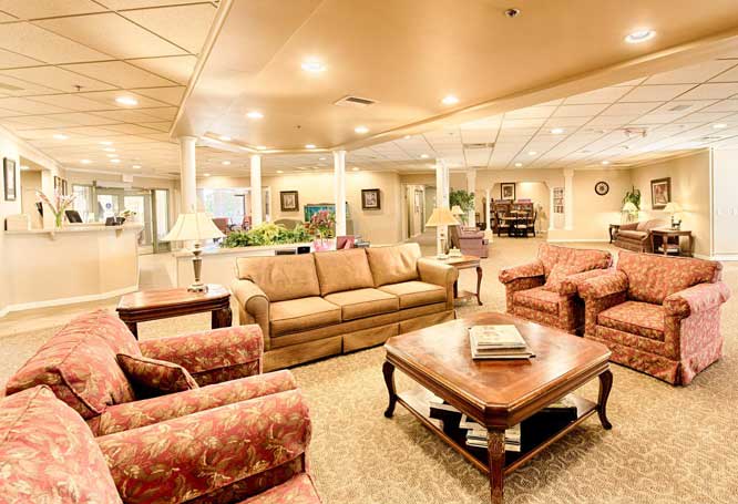 Elegant and spacious living room with comfortable seating and warm lighting.