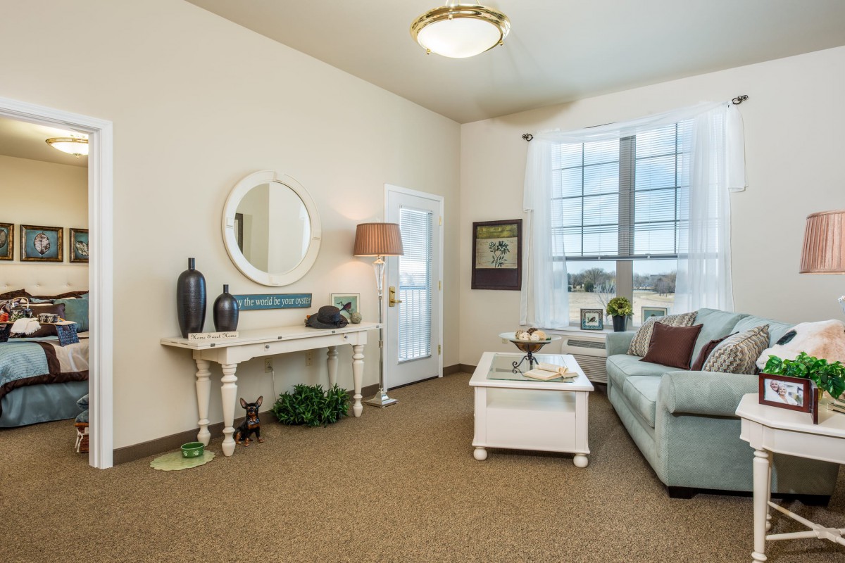 A cozy living room with a sofa, coffee table, and decorative items.