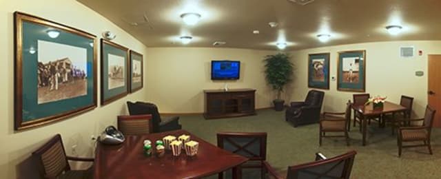 A cozy living room with a television and comfortable seating arrangement.