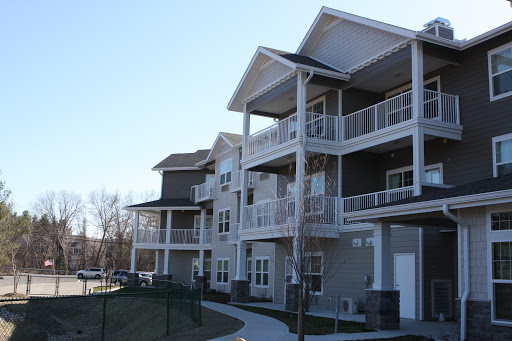 A modern apartment complex featuring multiple levels and balconies.