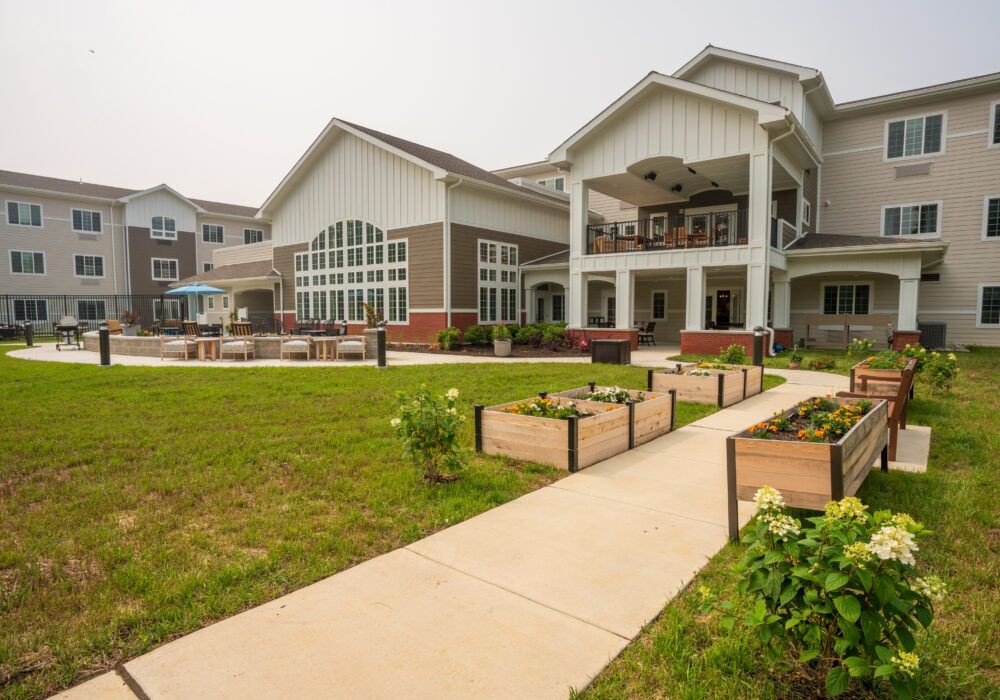 A modern building with a landscaped garden and pathway.