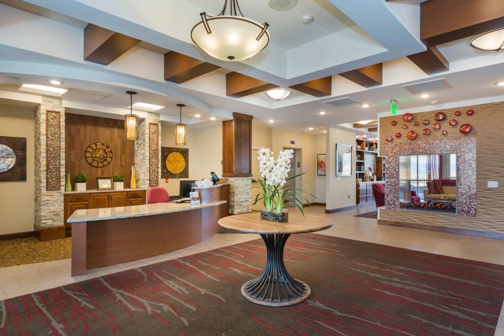 A well-lit lobby with a reception desk and elegant interior decor.