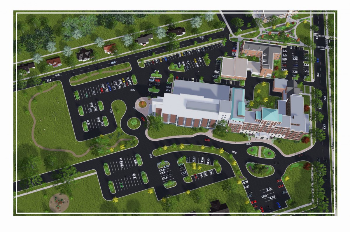 An aerial view of a building complex with surrounding parking lots and landscaped areas.