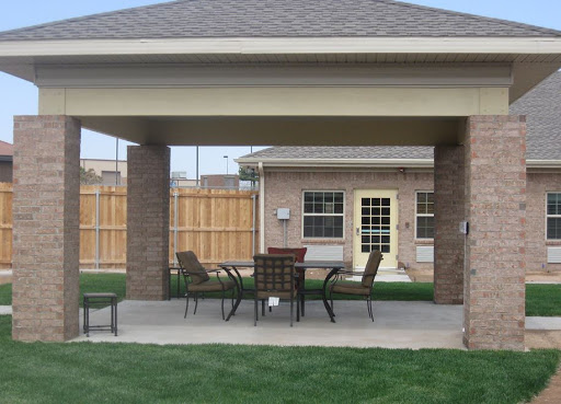 A cozy outdoor patio area with a gazebo, table, and chairs, perfect for relaxing in the backyard.