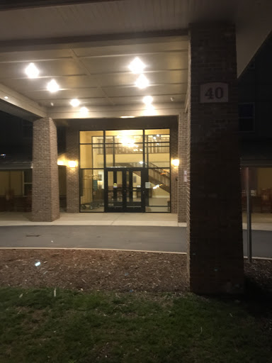A well-lit entrance of a modern building captured at night.
