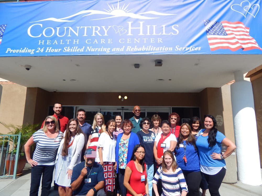A group of people standing in front of Country Hills Health Care Center.