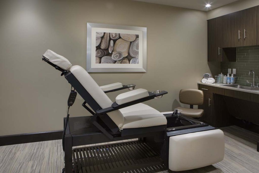 A tranquil spa room featuring a comfortable massage chair and soothing decor.