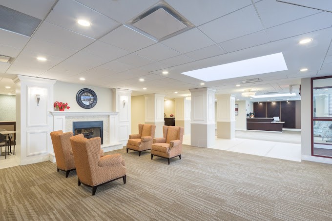 A modern lobby with comfortable seating and a fireplace.