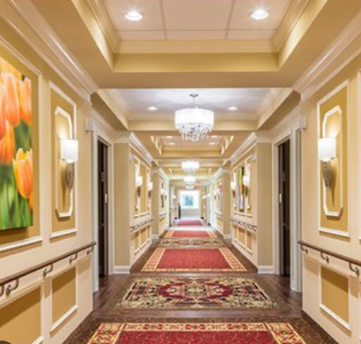 A beautifully decorated hotel hallway featuring elegant lighting and vibrant artwork.