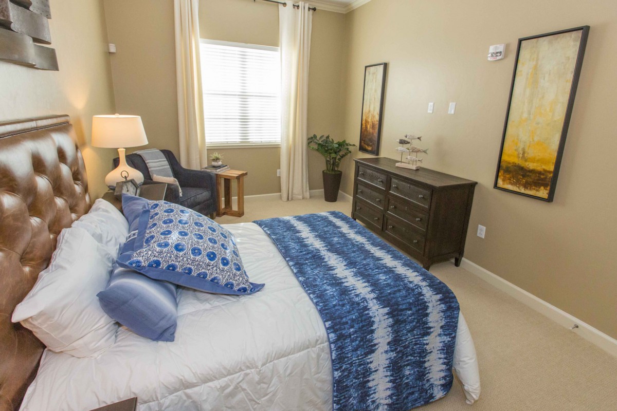 A cozy bedroom with blue accents and elegant furnishings.