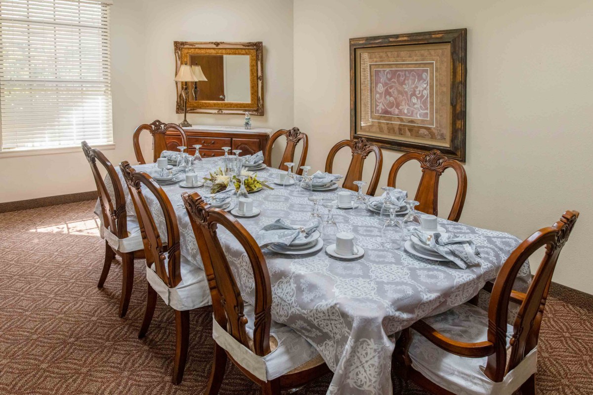 A beautifully set dining table with elegant chairs and tasteful decor.