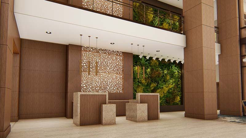 A modern lobby with a green wall and wooden reception desks, showcasing contemporary interior design.