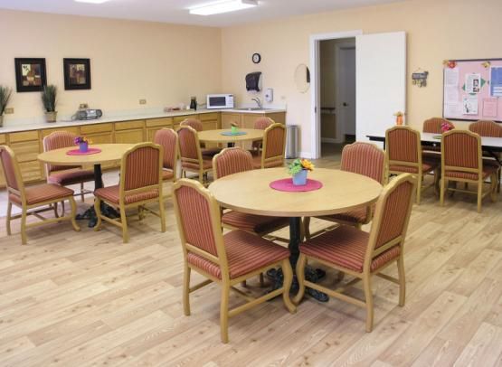 A tidy dining area with several tables and chairs arranged neatly.