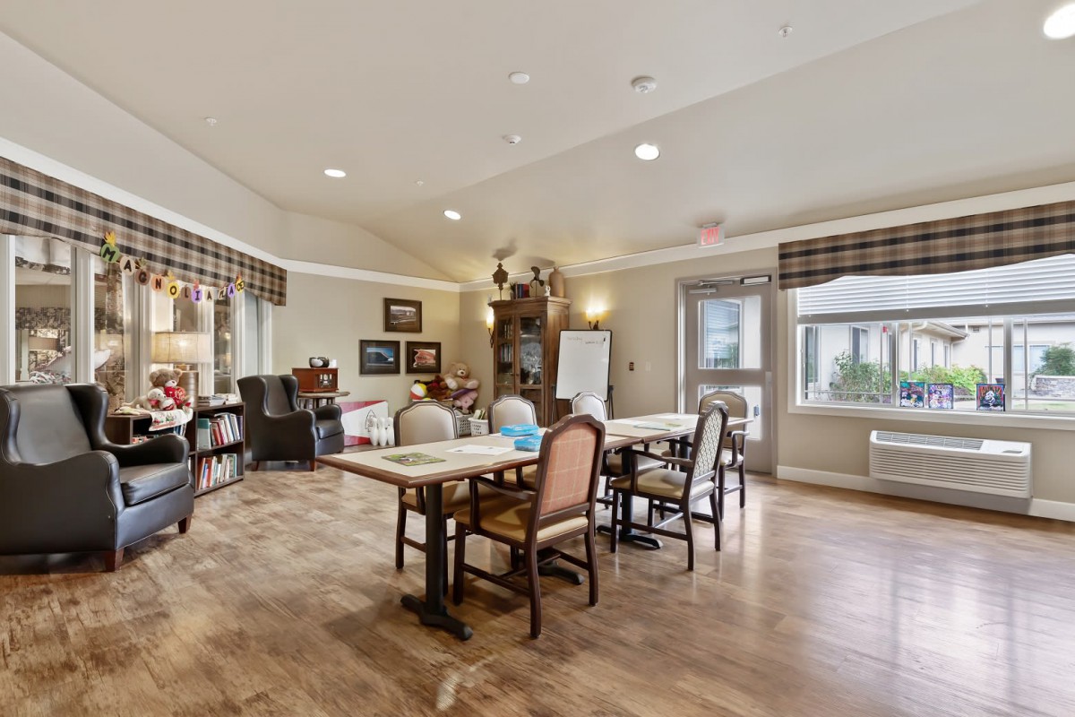 A spacious dining room with elegant furniture and warm decor.