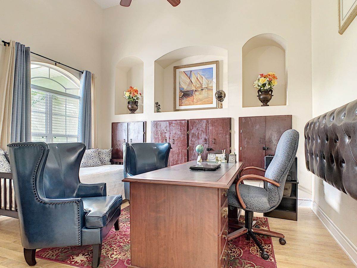 A well-decorated office space with a large desk, comfortable chairs, and elegant decor.