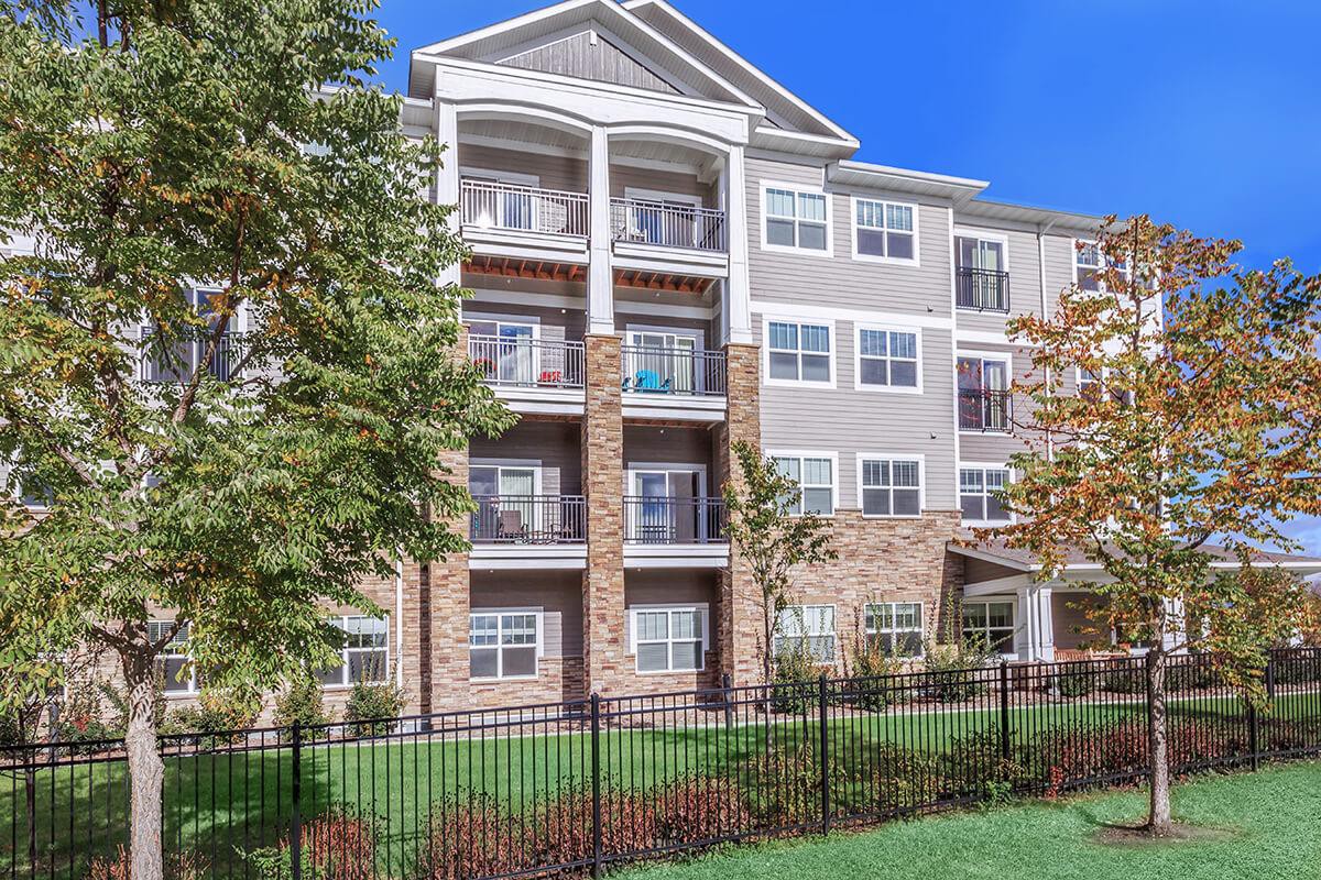 A modern apartment building with balconies and well-maintained landscaping.