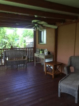 A cozy outdoor patio area with seating and garden views.