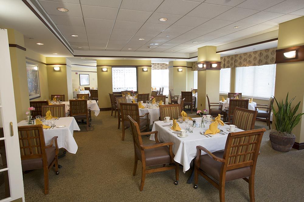 Spacious dining room with elegantly set tables and comfortable seating.