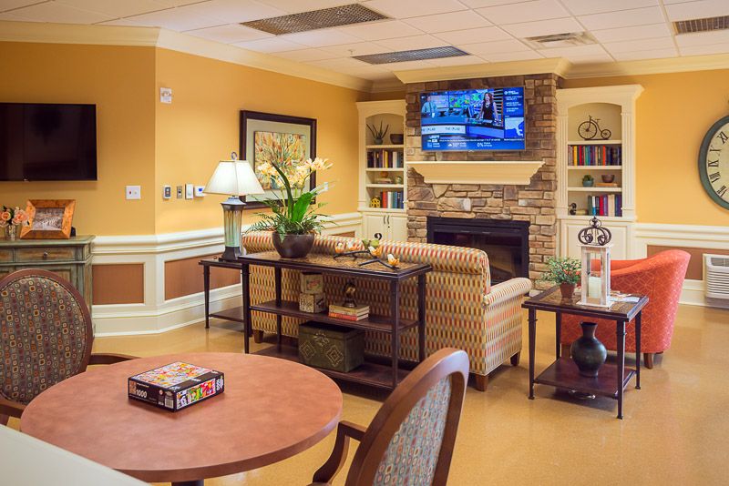 A cozy living room featuring a fireplace, television, and comfortable seating.