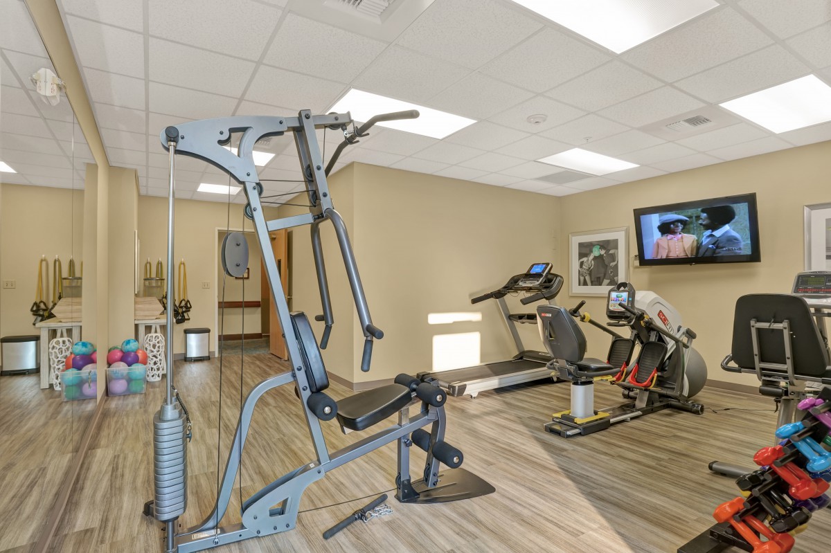 A modern gym with various fitness equipment and exercise machines.