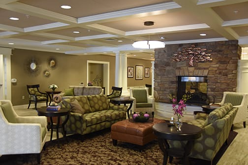 A cozy living room with comfortable seating, a fireplace, and elegant decor.