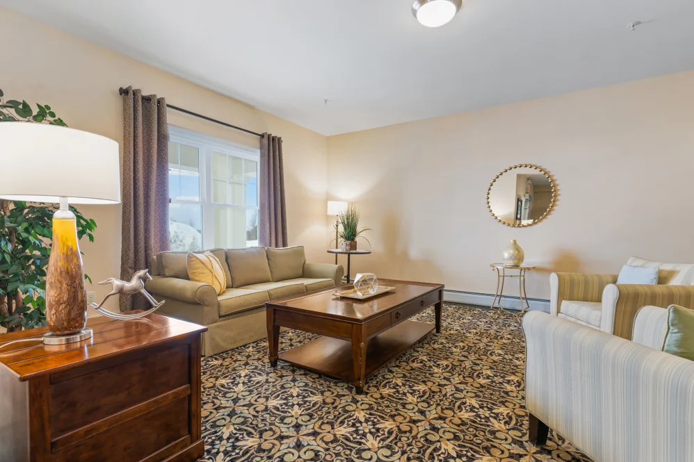 A cozy living room with a sofa, coffee table, and decorative elements.