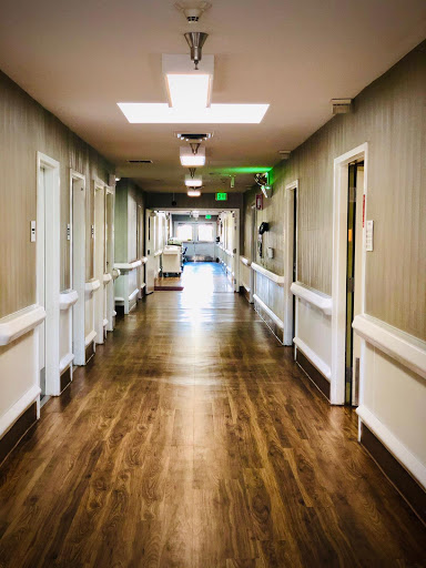 A clean and well-lit hallway in a healthcare facility.