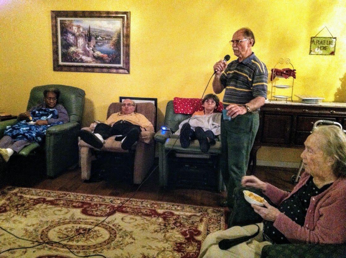 A relaxed family gathering with a karaoke session in the living room.
