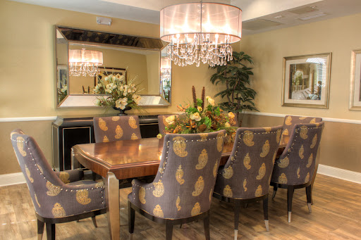 A beautifully designed dining room featuring stylish chairs, a wooden table, and an elegant chandelier.