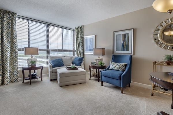 A modern living room with stylish furniture and large windows.