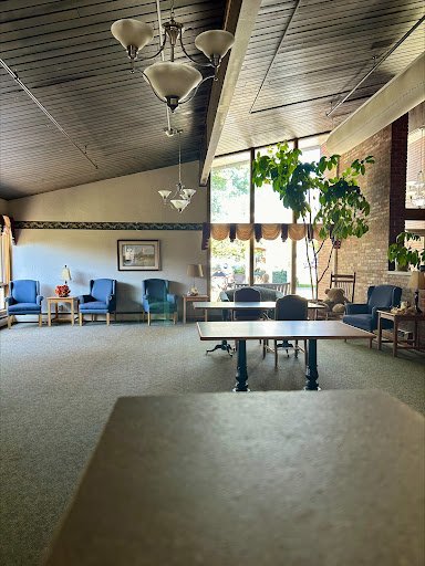 A spacious lounge area featuring comfortable seating and abundant natural light.