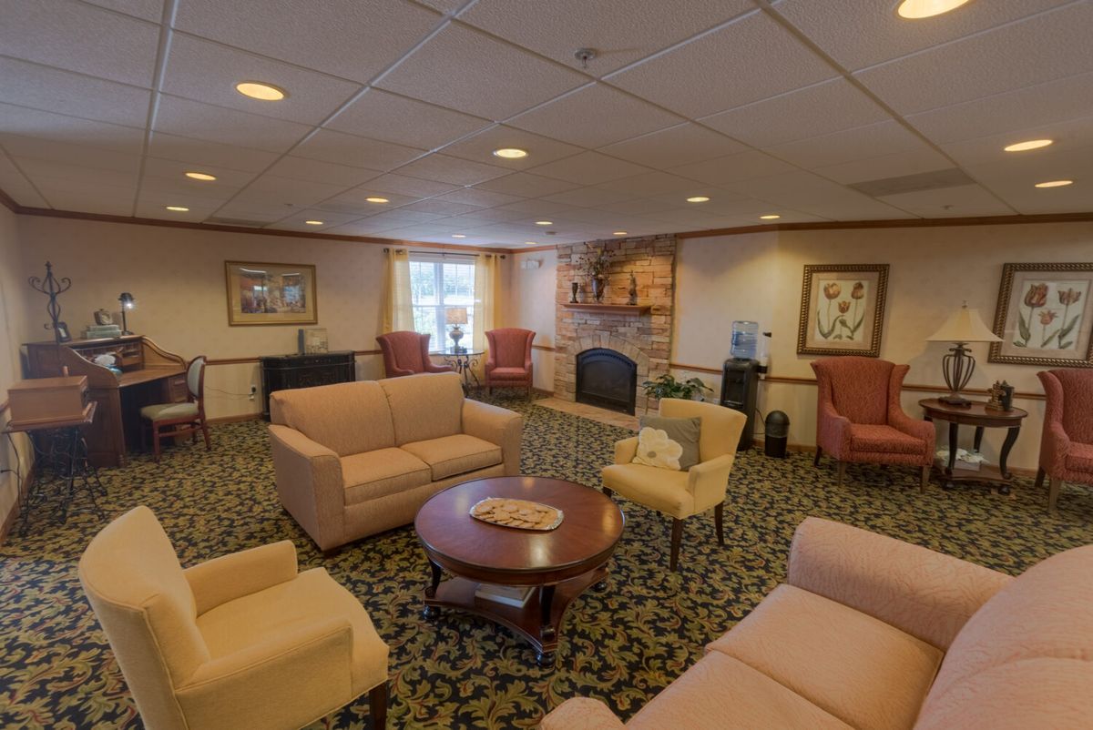 A cozy lounge area with sofas, chairs, and a coffee table.